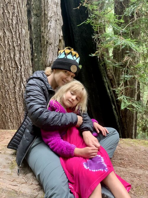 woman with girl in fuchsia dress in redwoods